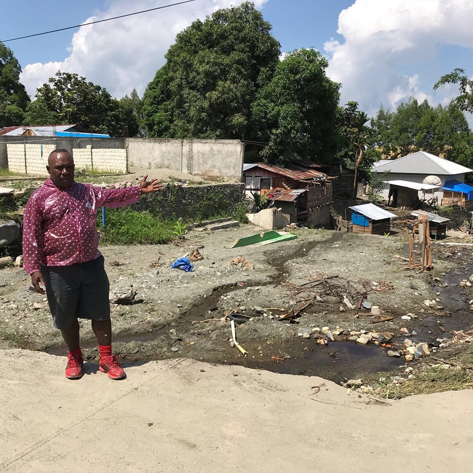 Pointing at the place where his two story house used to be.
